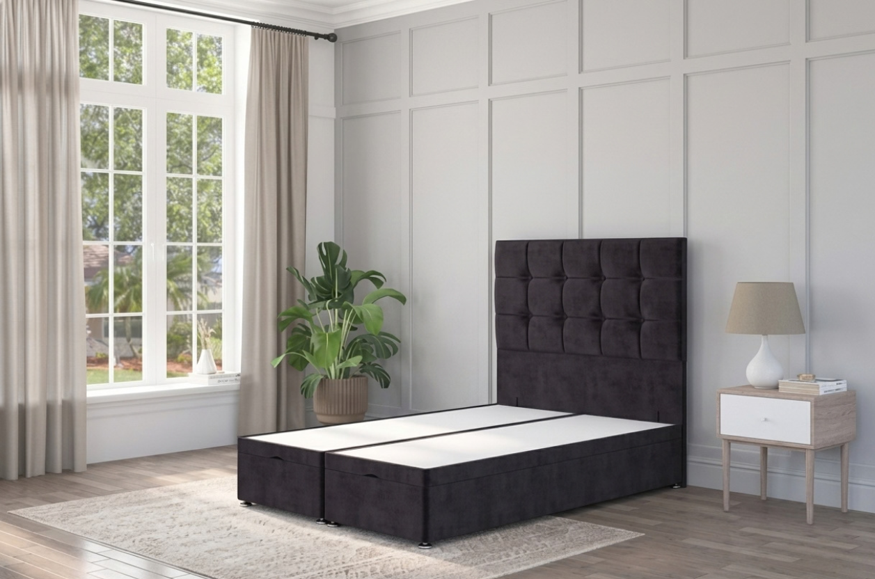 A black ottoman bed with a traditional chesterfield style headboard, displayed in a modern bedroom interior.